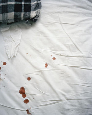 Red wine stains on white bamboo bed sheets
