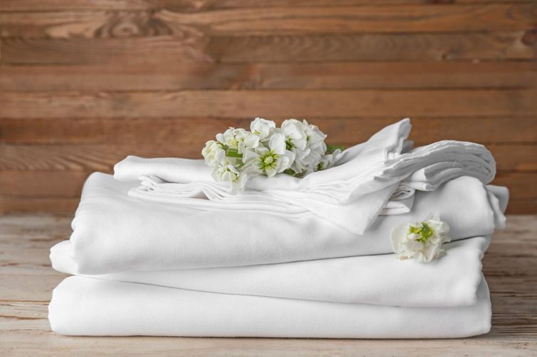 A stack of clean white bamboo bed sheets