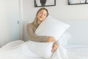 A Canadian Woman on Snoozy Monk Bamboo Bed Sheets in a White bedroom setting